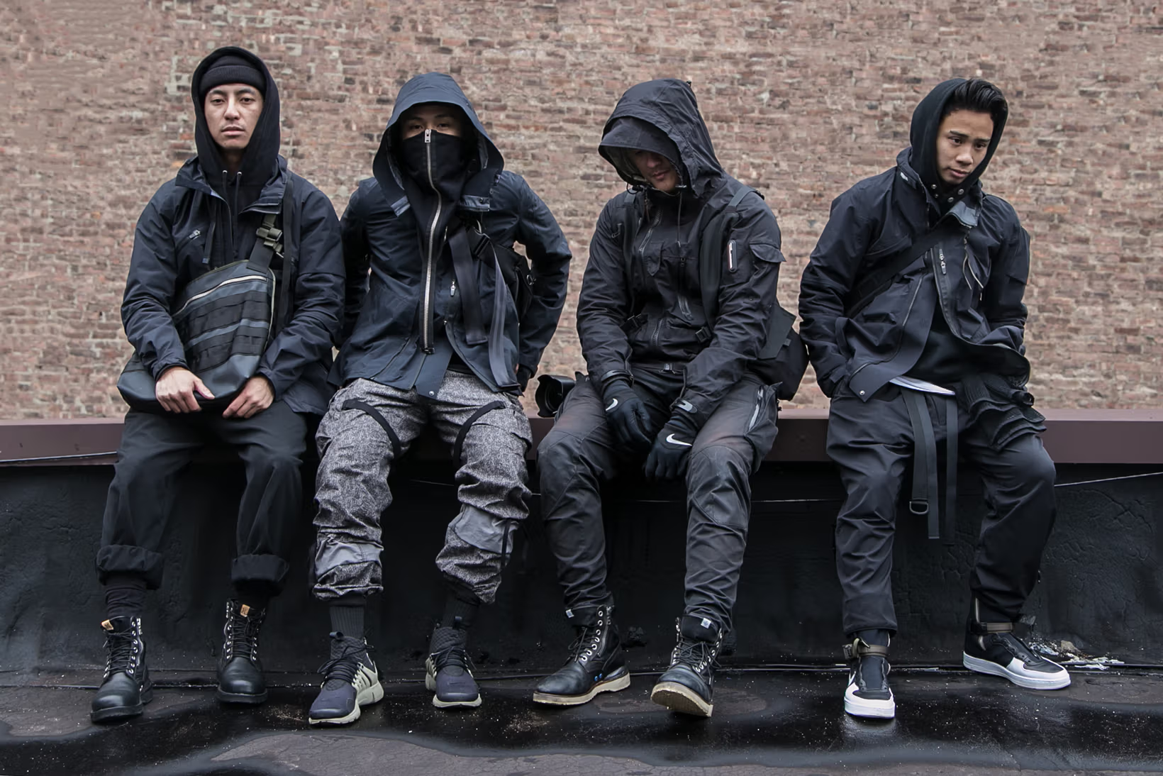 techwear enthusiasts sitting in the street